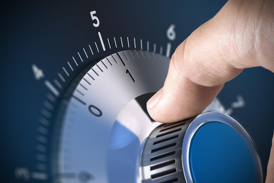 A finger turning a precision dial to set a value